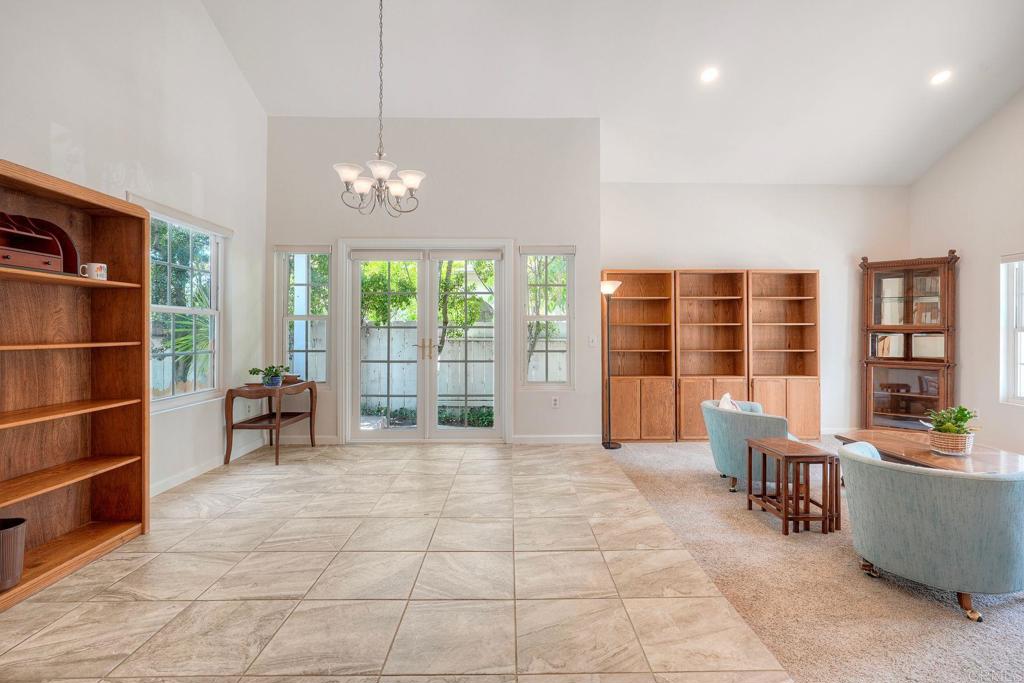 13639 Freeport Road San Diego, CA 92129 - Photo 5 of 44 a living room with furniture a chandelier and a large window