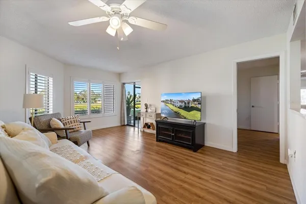 a living room with furniture and wooden floor