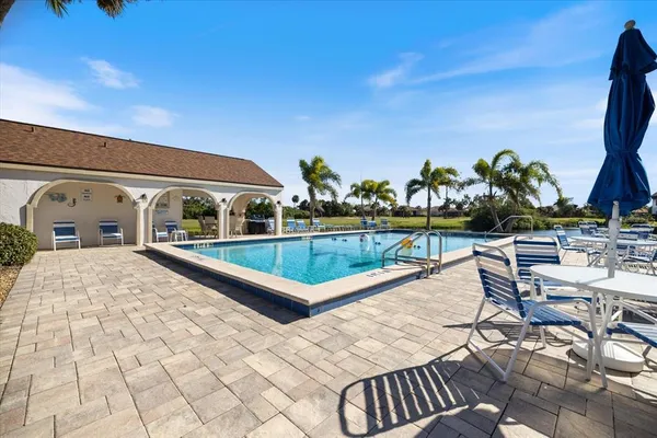 a view of a swimming pool with furniture