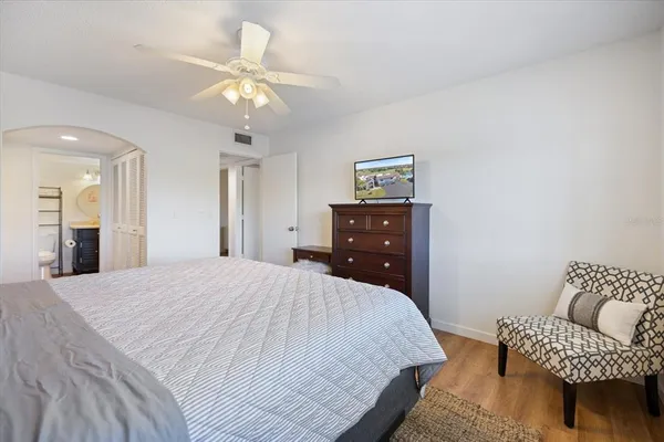 a bedroom with a bed and a chair