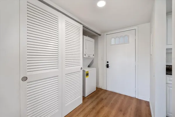 a view of a hallway with wooden floor and staircase