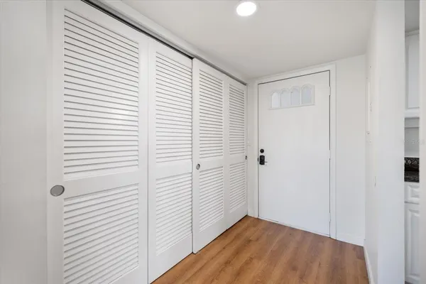 a view of a room with wooden floor