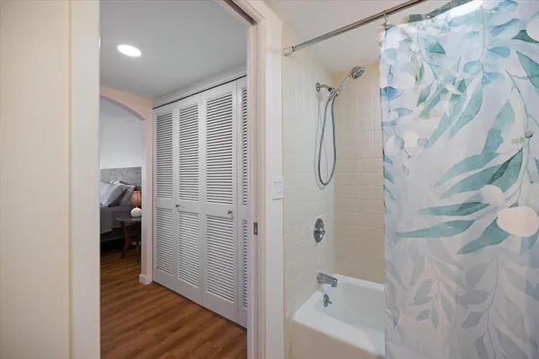 a bathroom with a bathtub and a shower