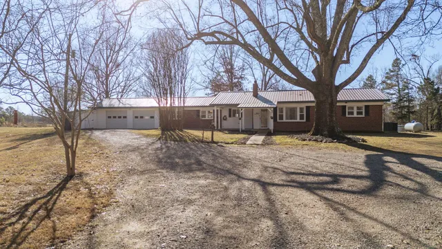 a view of house with a yard covered in snow
