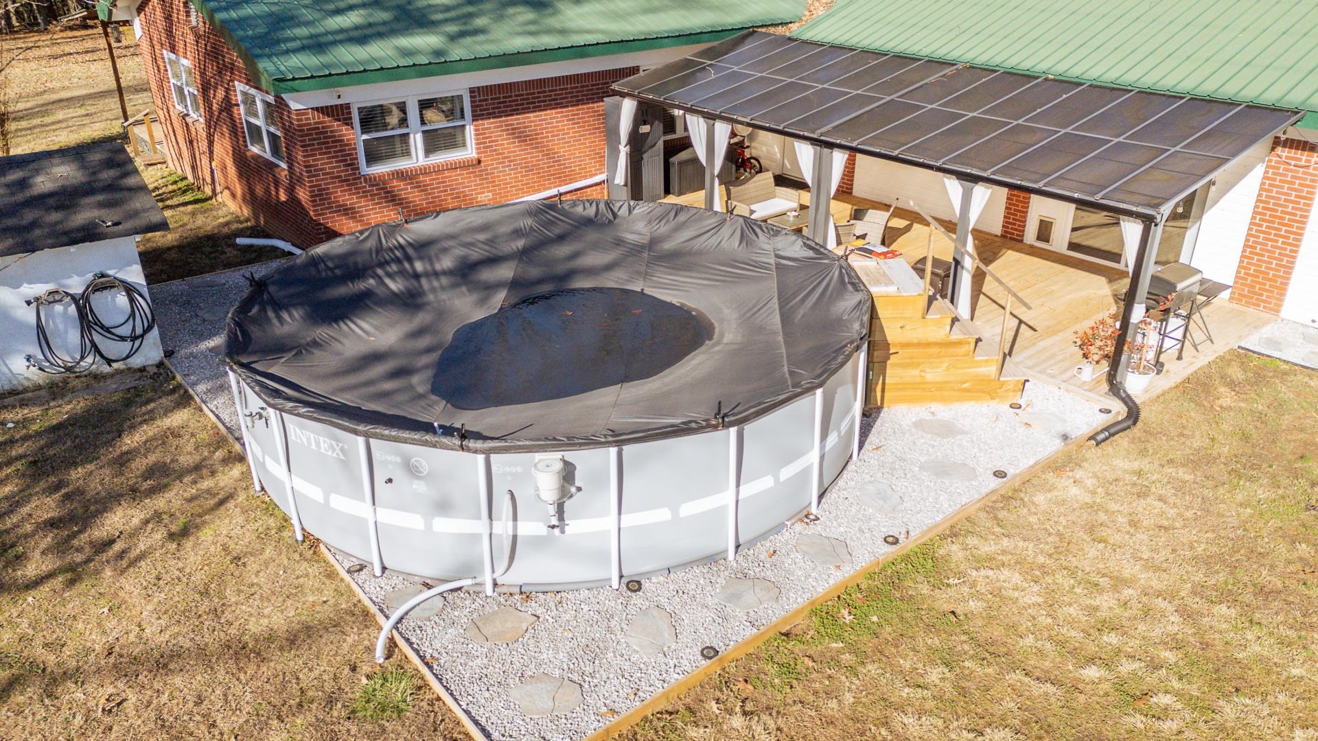 865 Pickett Road Stantonville, TN 38379 - Photo 4 of 40 Exterior view of brick siding, a pool, and a metal roof