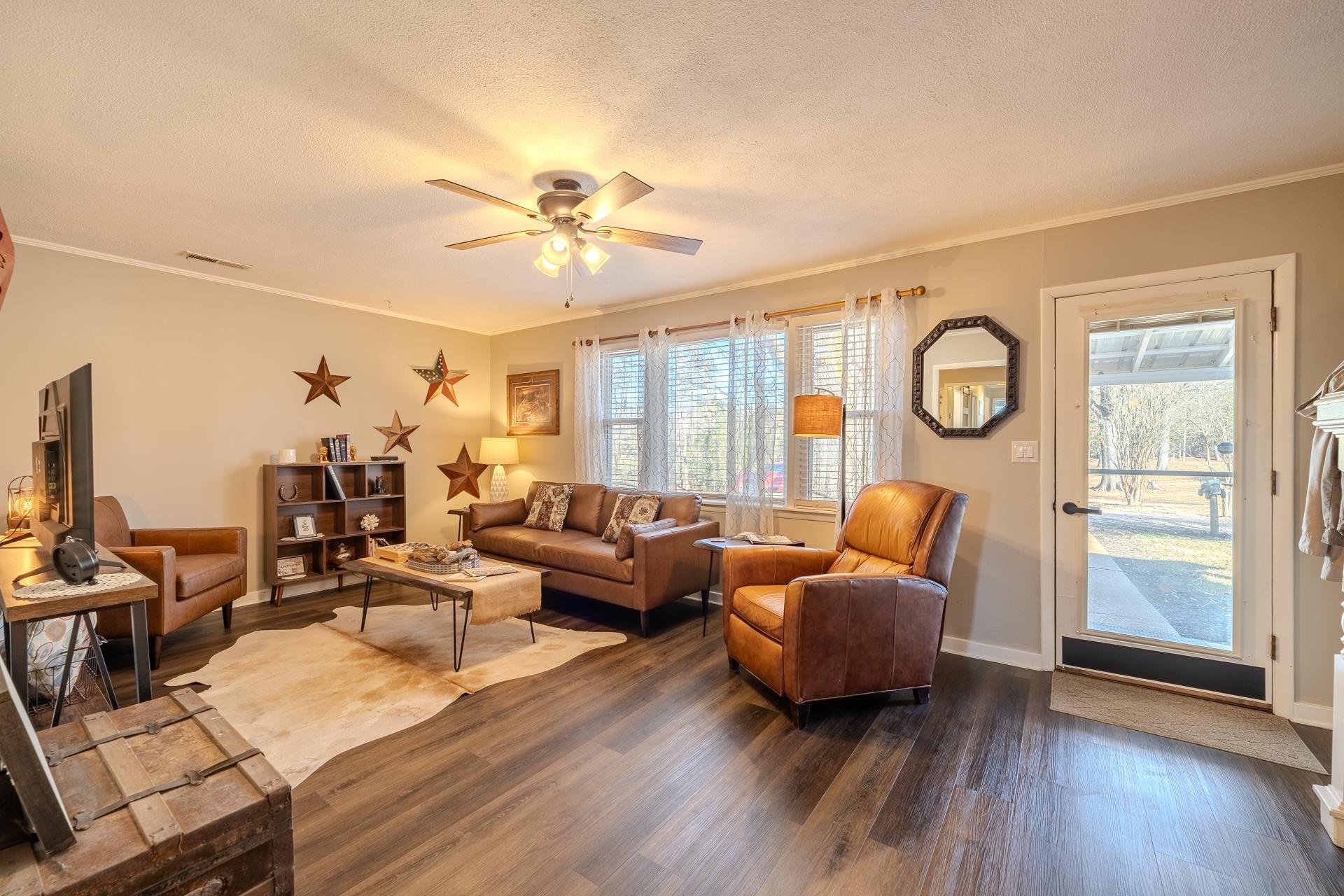 865 Pickett Road Stantonville, TN 38379 - Photo 8 of 40 Living area with ornamental molding, dark wood-style flooring, a textured ceiling, and a ceiling fan