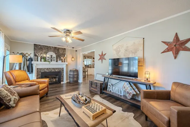 a living room with furniture a fireplace and a flat screen tv