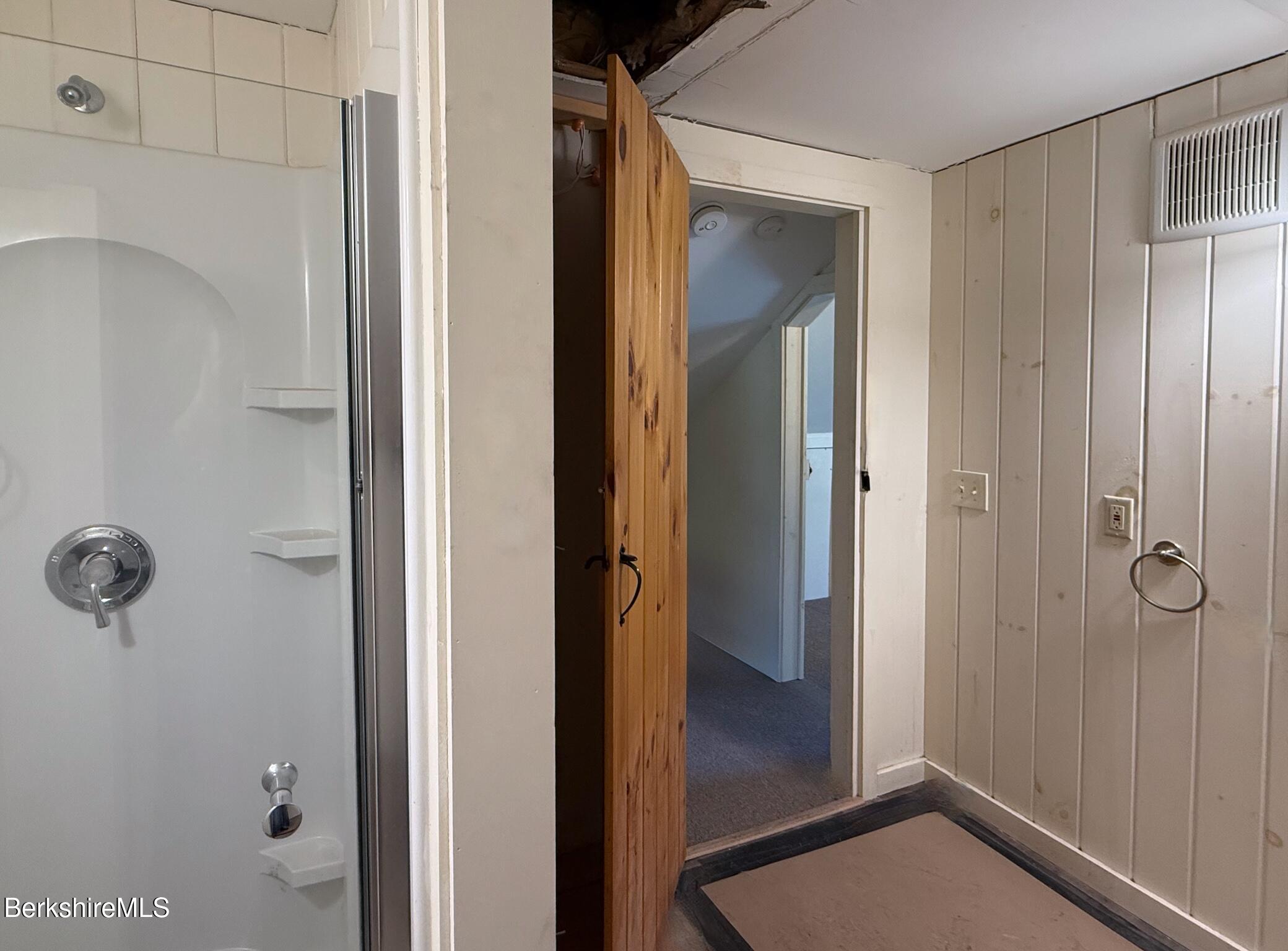 783 Main Street Great Barrington, MA 01230 - Photo 14 of 31 a view of a bathroom with a glass door and mirror