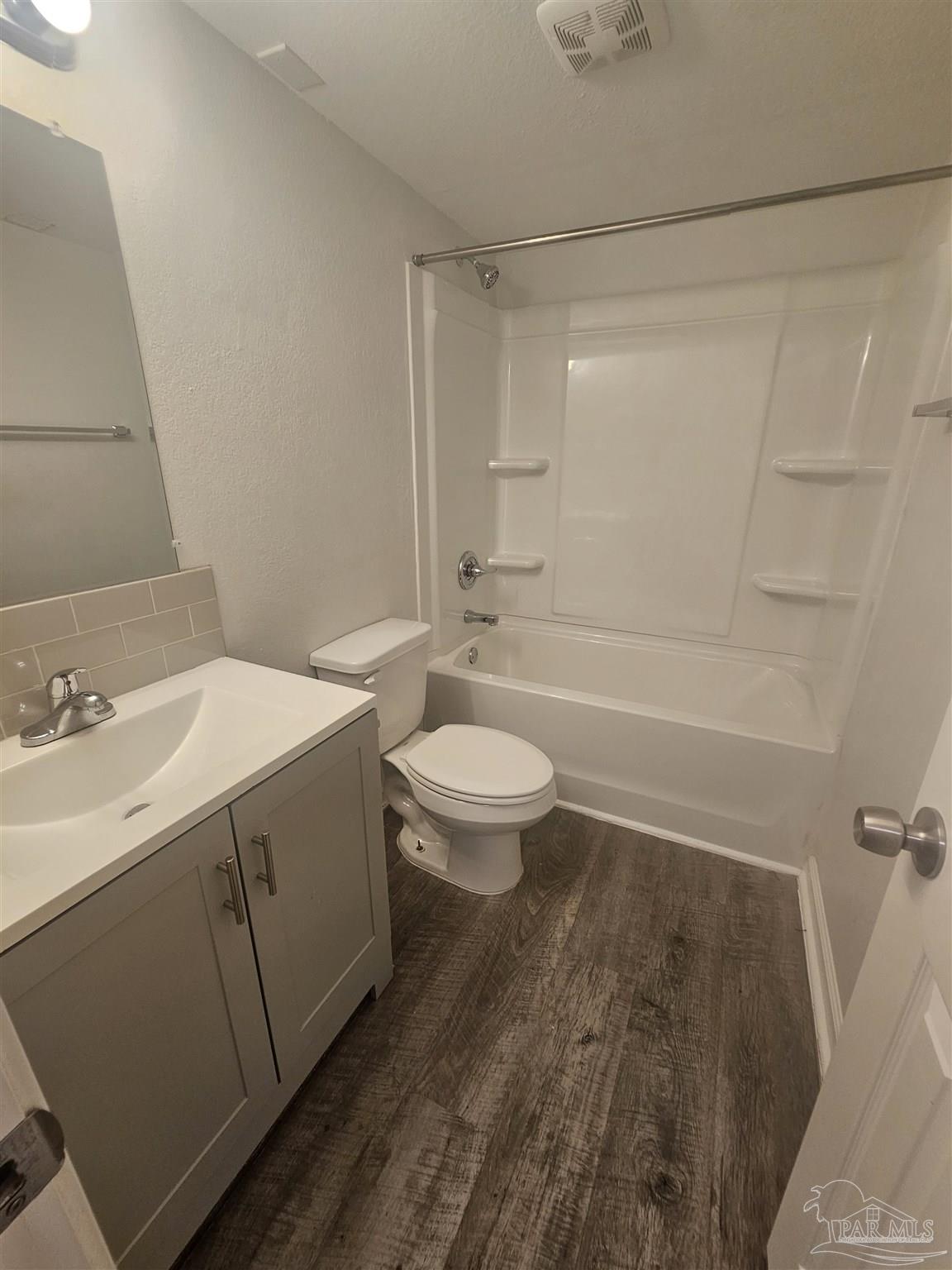 751 Tumbleweed Trail, Unit A Pensacola, FL 32534 - Photo 7 of 13 a bathroom with a sink a toilet and a large mirror