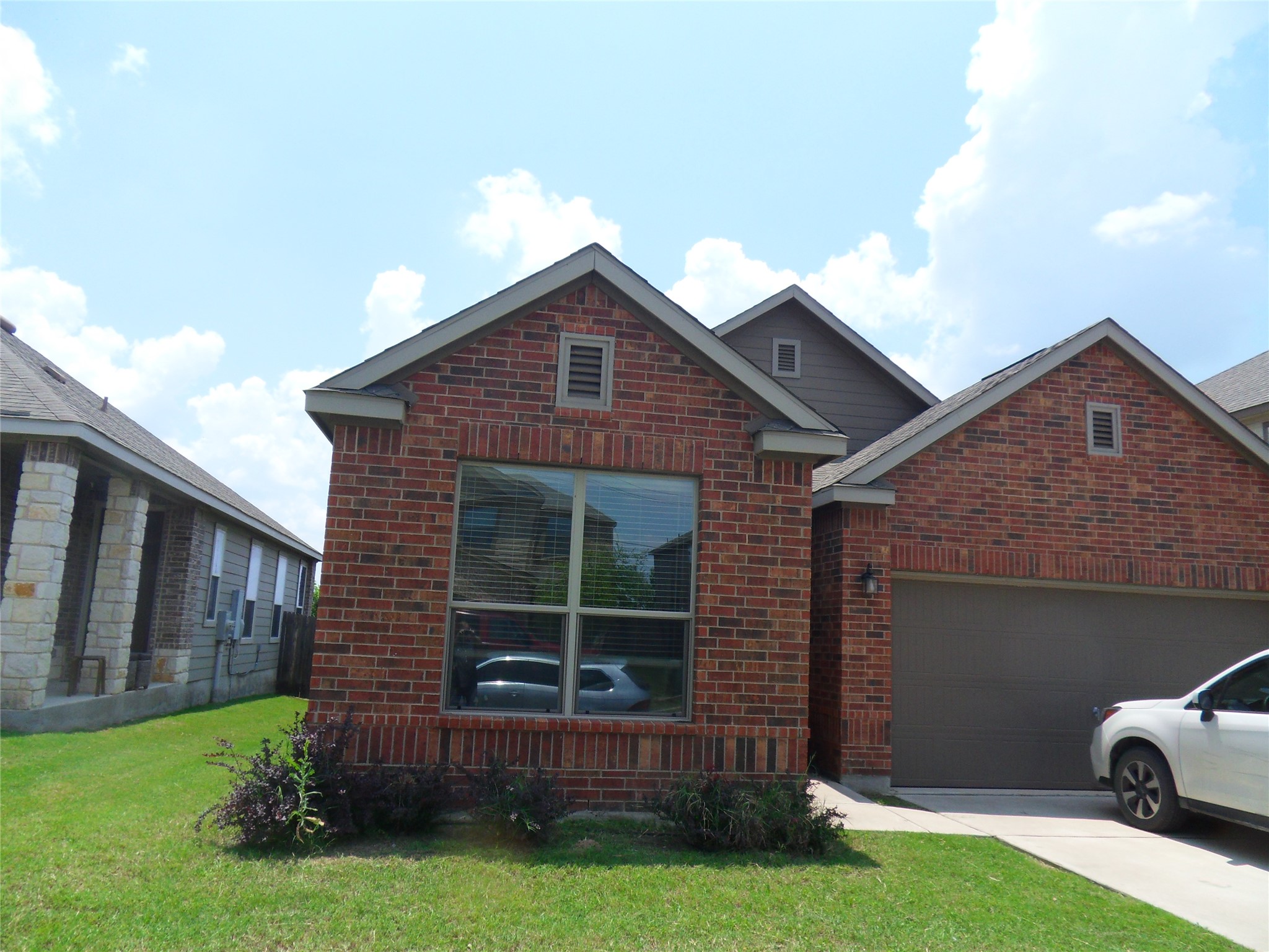 11013 Kirkoswald Road Austin, TX 78754 - Photo 2 of 20 Classic brick exterior and an attached garage create exceptional curb appeal.