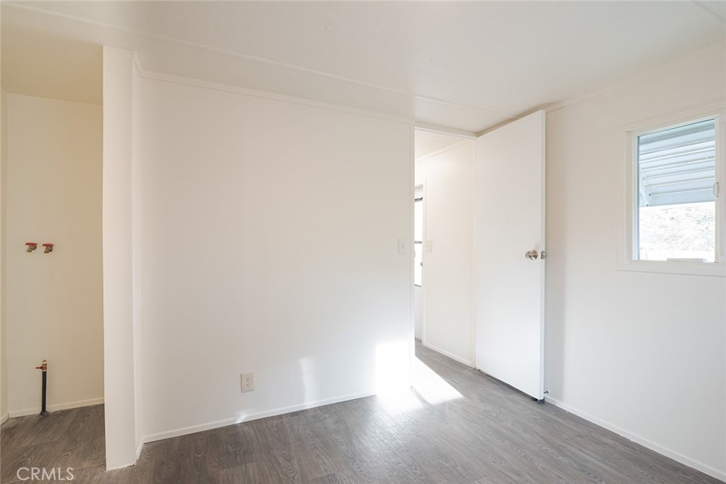 73 Alesandro Road, Unit A Palm Springs, CA 92264 - Photo 13 of 23 a view of a small space with wooden floor and a window