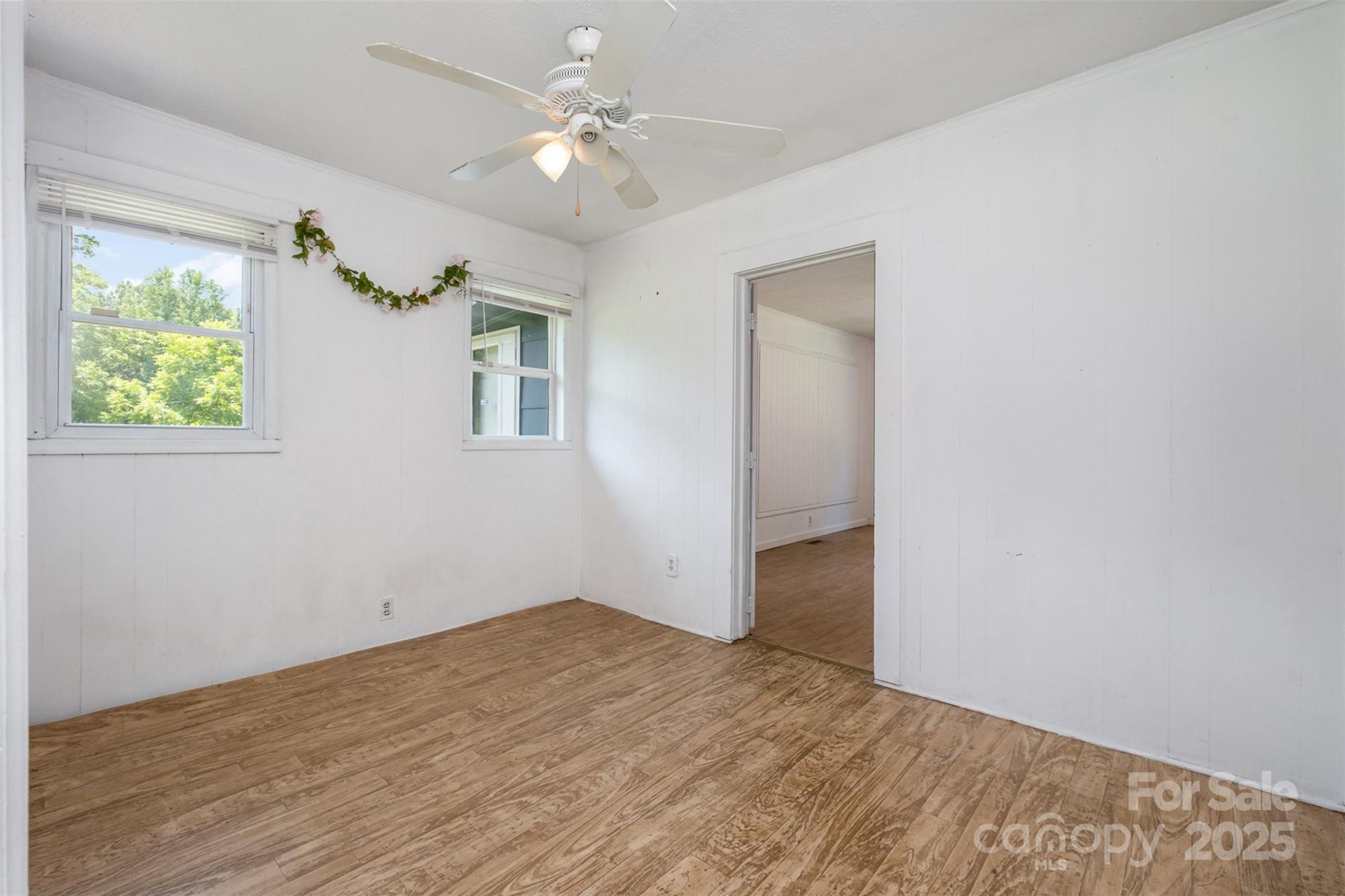 1043 Sid Davis Road Chester, SC 29706 - Photo 12 of 25 a view of empty room with wooden floor and fan
