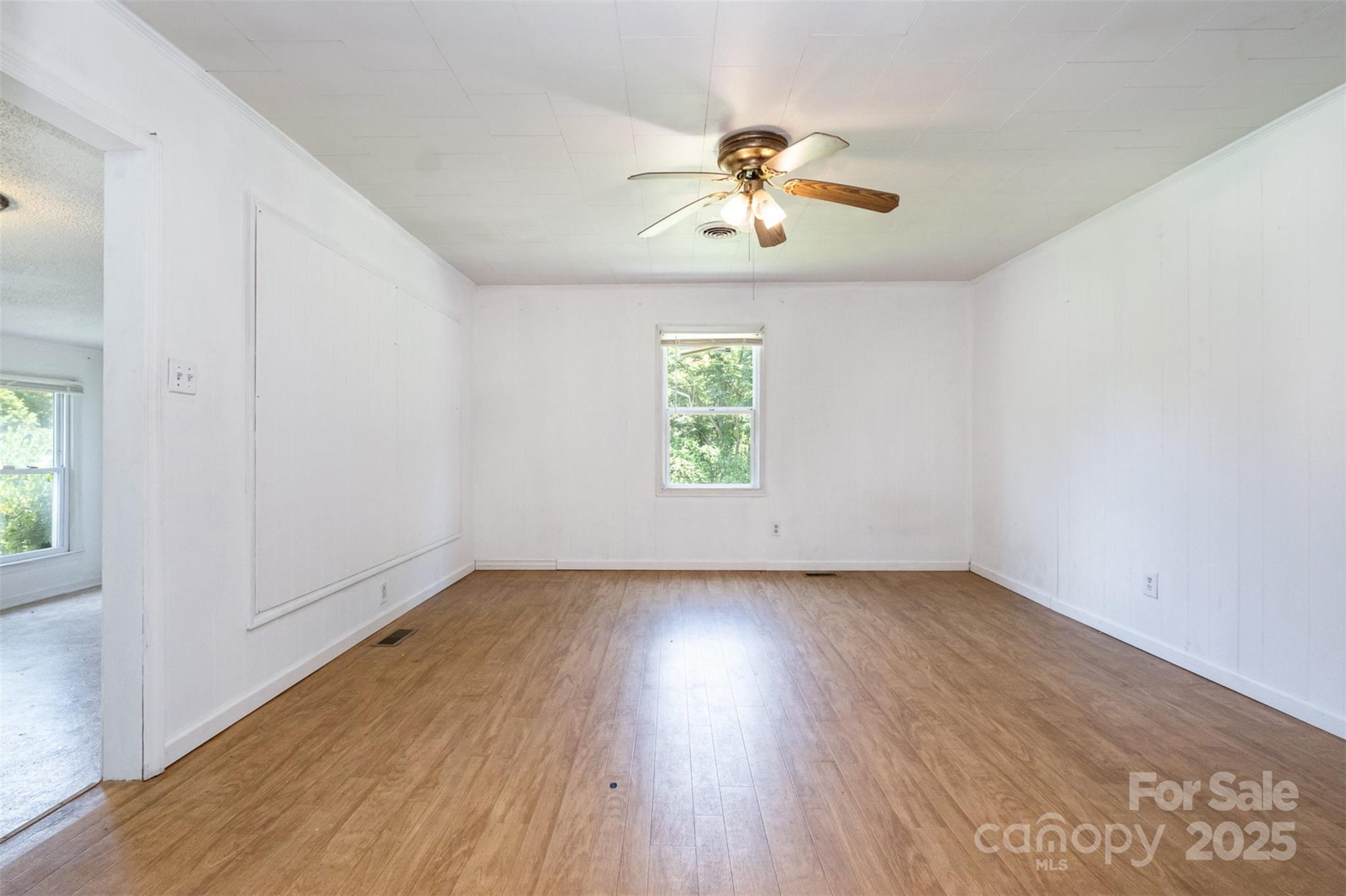 1043 Sid Davis Road Chester, SC 29706 - Photo 13 of 25 an empty room with wooden floor chandelier fan and windows