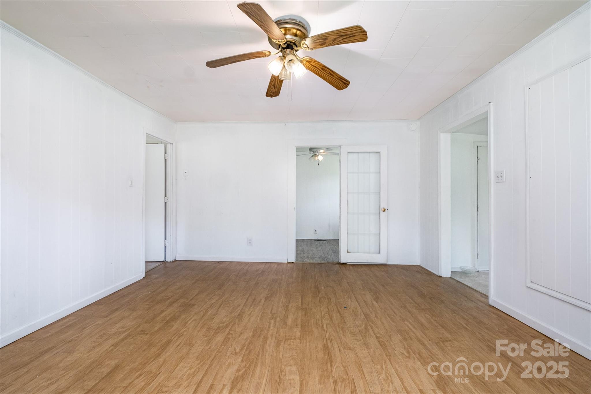1043 Sid Davis Road Chester, SC 29706 - Photo 14 of 25 a view of a room with wooden floor and a ceiling fan