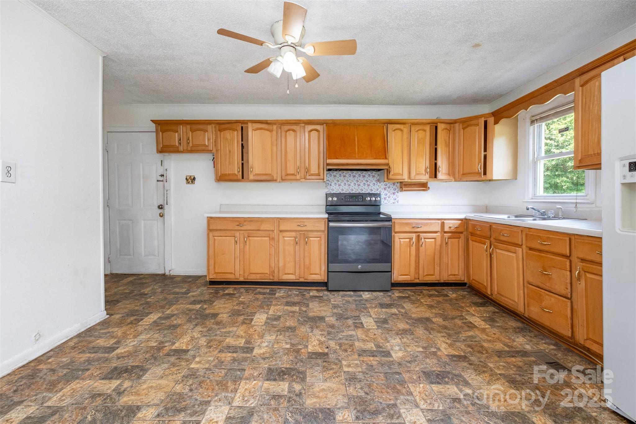 1043 Sid Davis Road Chester, SC 29706 - Photo 7 of 25 a kitchen with a stove a sink and a window