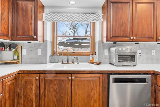 a kitchen with stainless steel appliances wooden cabinets and a sink