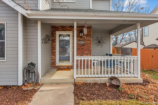 a porch with a table and chairs