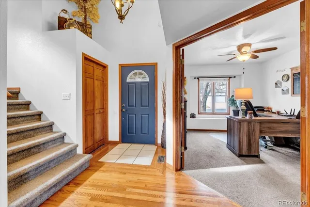 a view of a livingroom with furniture and staircase