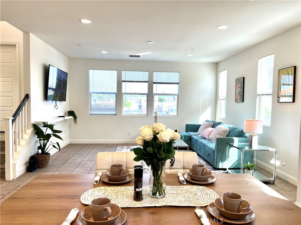 1207 Alpine Circle Baldwin Park, CA 91706 - Photo 11 of 38 a living room with furniture a flat screen tv and a window