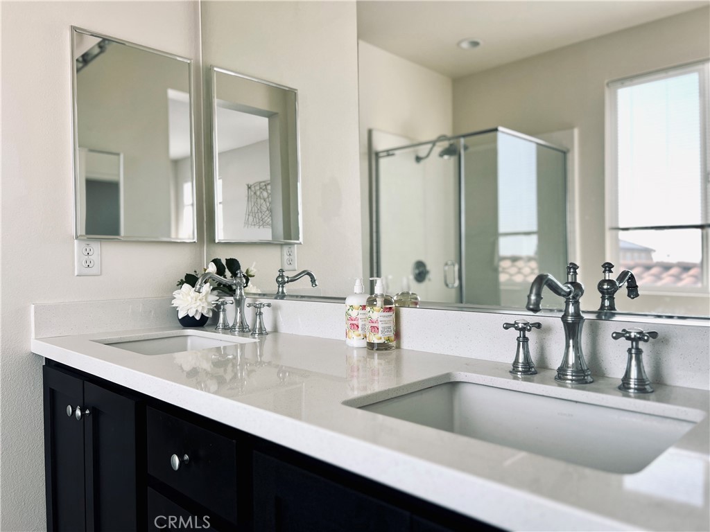 1207 Alpine Circle Baldwin Park, CA 91706 - Photo 18 of 38 a bathroom with double vanity sinks and a mirror
