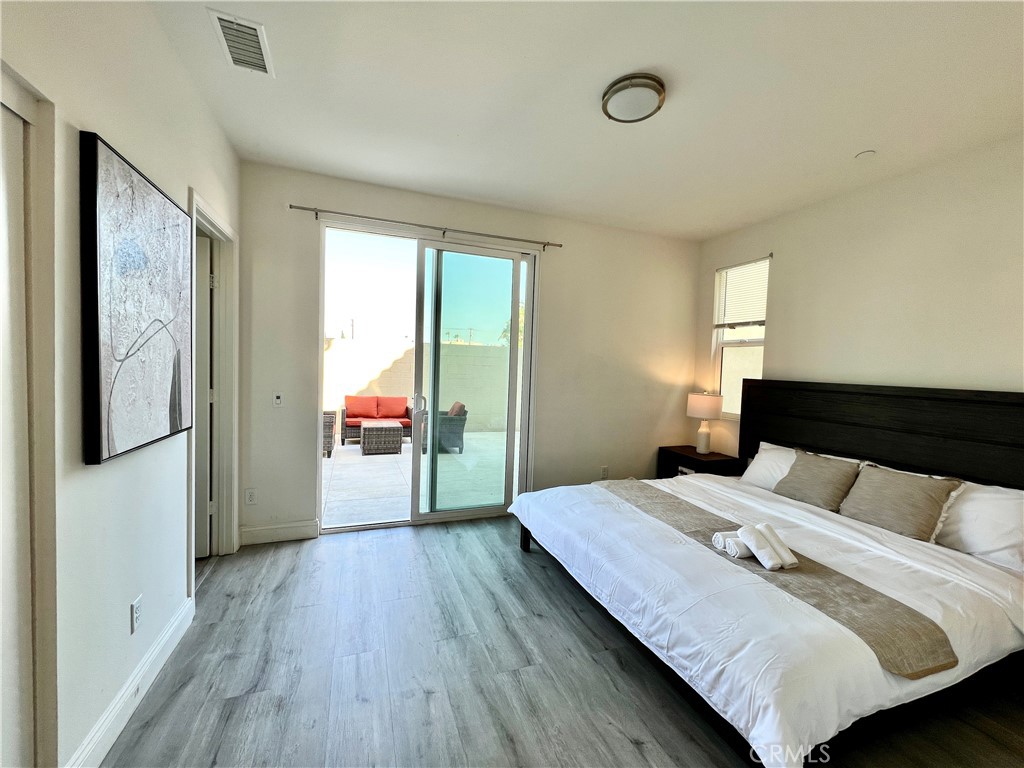 1207 Alpine Circle Baldwin Park, CA 91706 - Photo 21 of 38 a bedroom with a bed and a large window