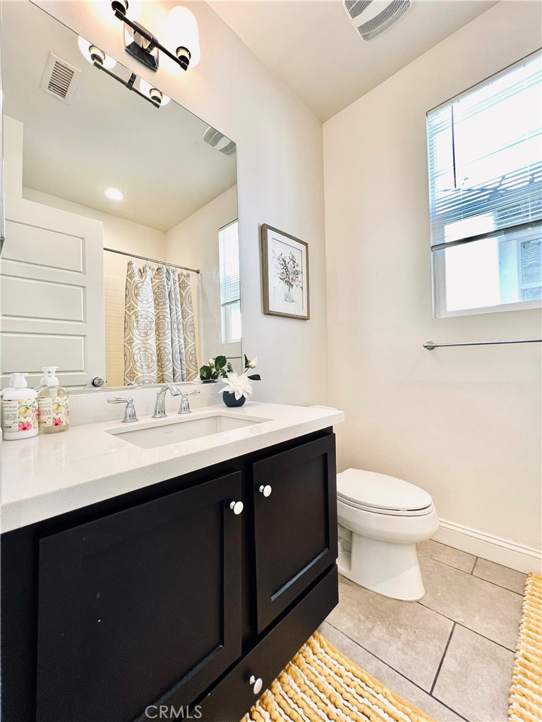 1207 Alpine Circle Baldwin Park, CA 91706 - Photo 26 of 38 a bathroom with a sink toilet and a mirror
