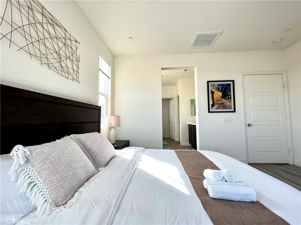 1207 Alpine Circle Baldwin Park, CA 91706 - Photo 27 of 38 a bedroom with a bed and a painting on the wall