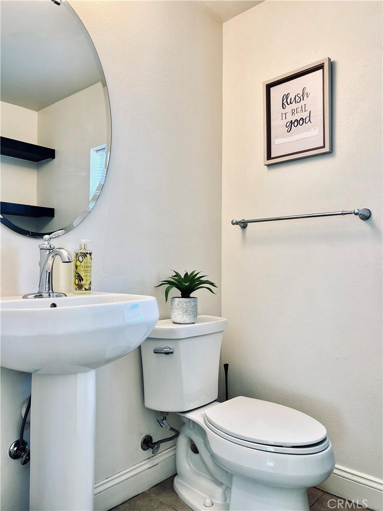 1207 Alpine Circle Baldwin Park, CA 91706 - Photo 33 of 38 a bathroom with a toilet sink and mirror