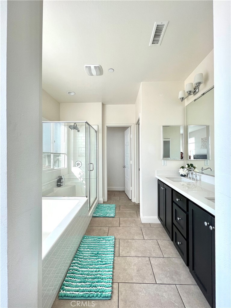 1207 Alpine Circle Baldwin Park, CA 91706 - Photo 34 of 38 a large bathroom with a sink a large mirror and a bathtub