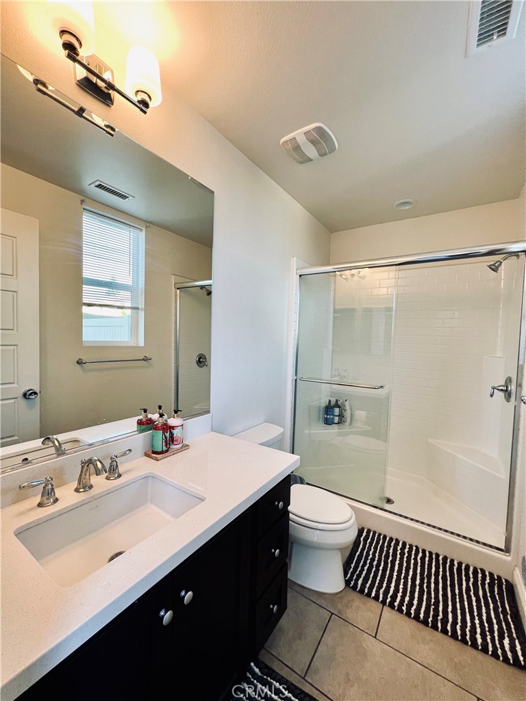 1207 Alpine Circle Baldwin Park, CA 91706 - Photo 36 of 38 a bathroom with a double vanity sink toilet mirror and bathtub