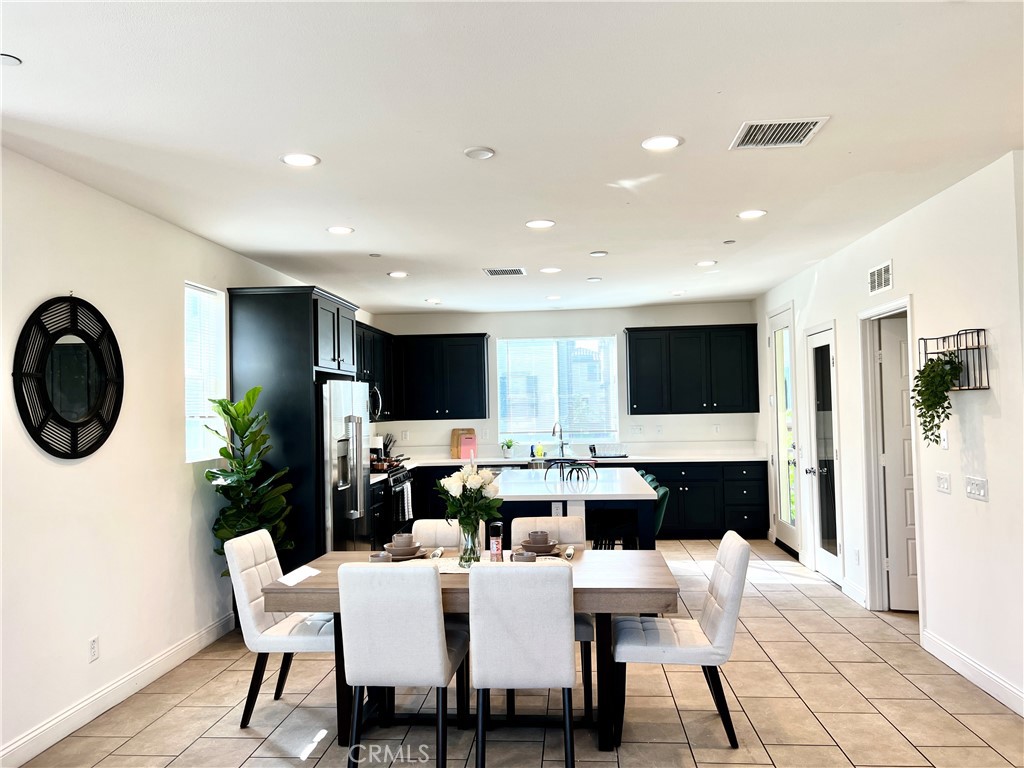 1207 Alpine Circle Baldwin Park, CA 91706 - Photo 8 of 38 a living room with furniture a flat screen tv and kitchen view