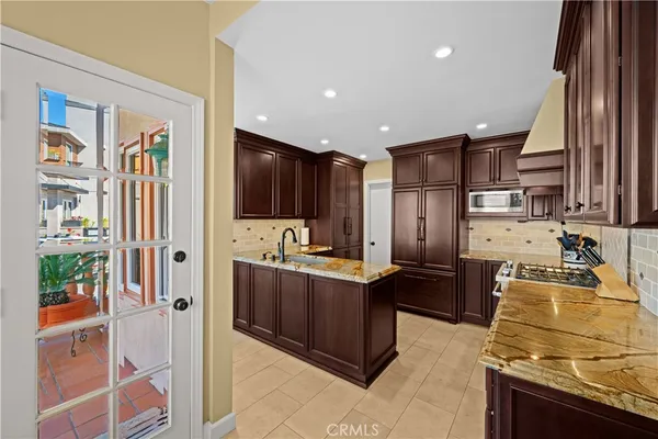 a kitchen with stainless steel appliances granite countertop a sink and a stove