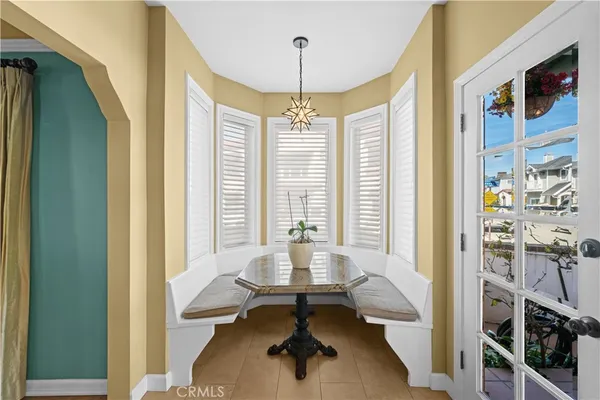 a bedroom with a bed lamps and wooden floor