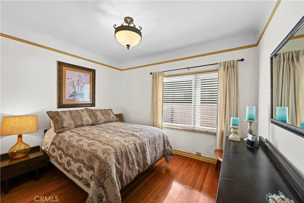 a large bedroom with a large bed and a large window