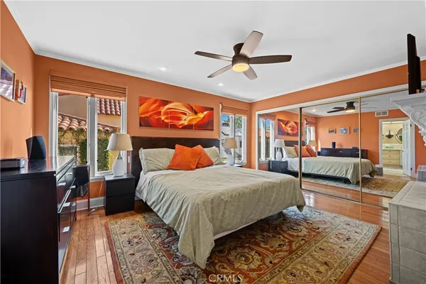 a spacious bedroom with a bed and a large window