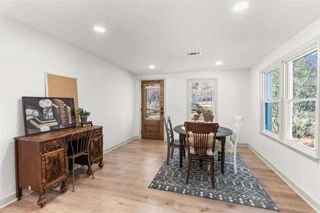 a dining room with furniture and wooden floor