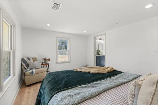 a bedroom with a bed and a couch