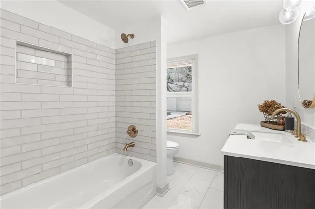 a bathroom with a bathtub sink and toilet