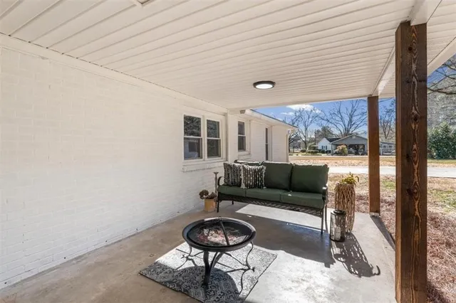 a living room with furniture and a floor to ceiling window