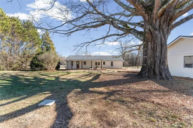 a view of house with yard