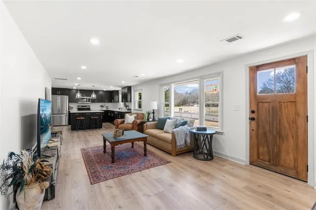 a living room with furniture and a flat screen tv