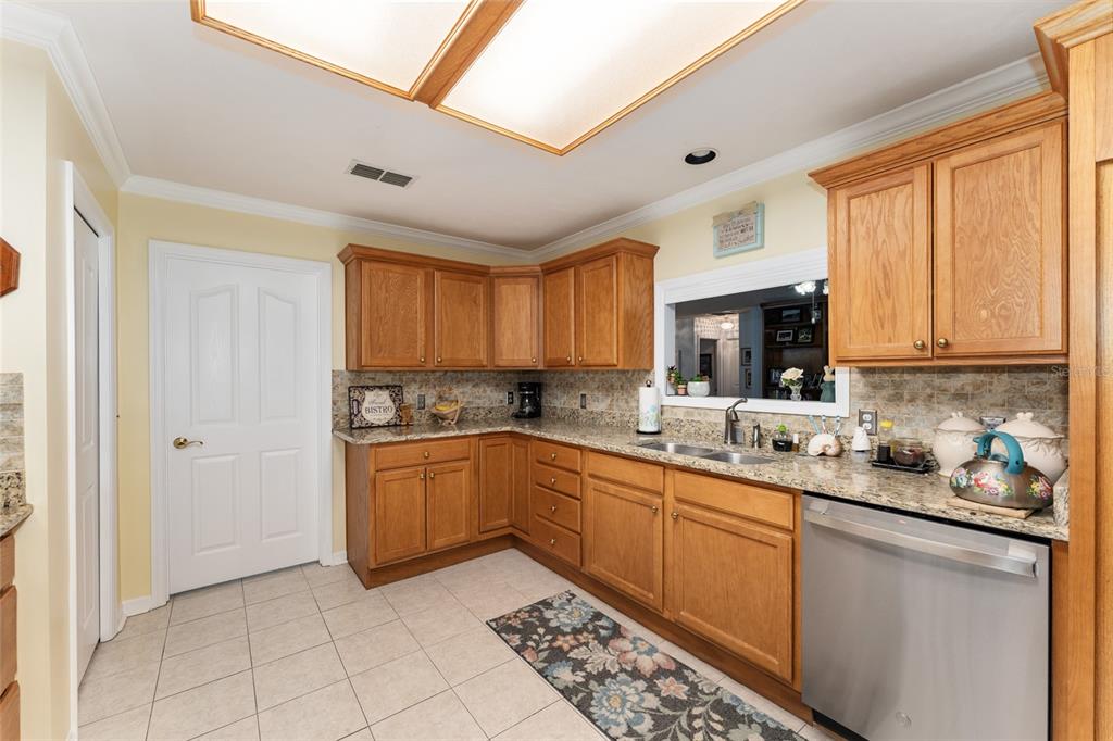 10922 Palmetto Boulevard Alachua, FL 32615 - Photo 11 of 51 a kitchen with a sink stove and cabinets