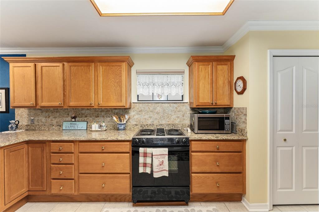 10922 Palmetto Boulevard Alachua, FL 32615 - Photo 12 of 51 a kitchen with a stove cabinets and a window