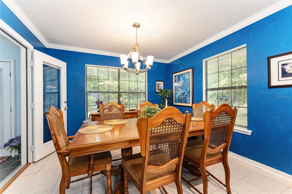 10922 Palmetto Boulevard Alachua, FL 32615 - Photo 15 of 51 a dining room with furniture a chandelier and window