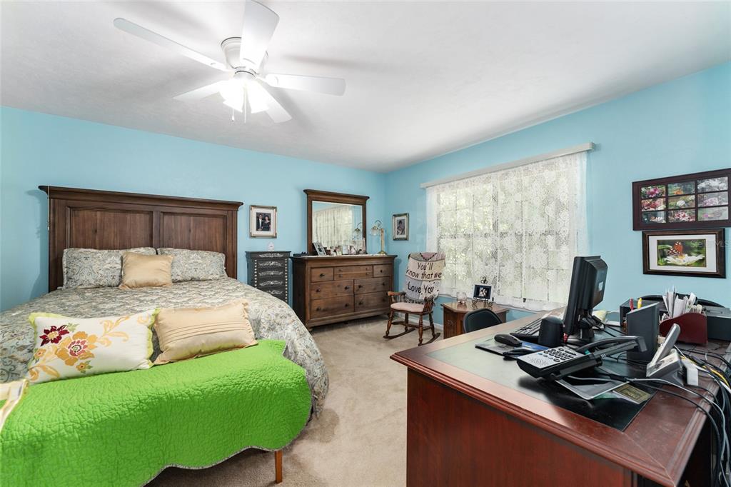 10922 Palmetto Boulevard Alachua, FL 32615 - Photo 17 of 51 a bedroom with a bed window and a desk