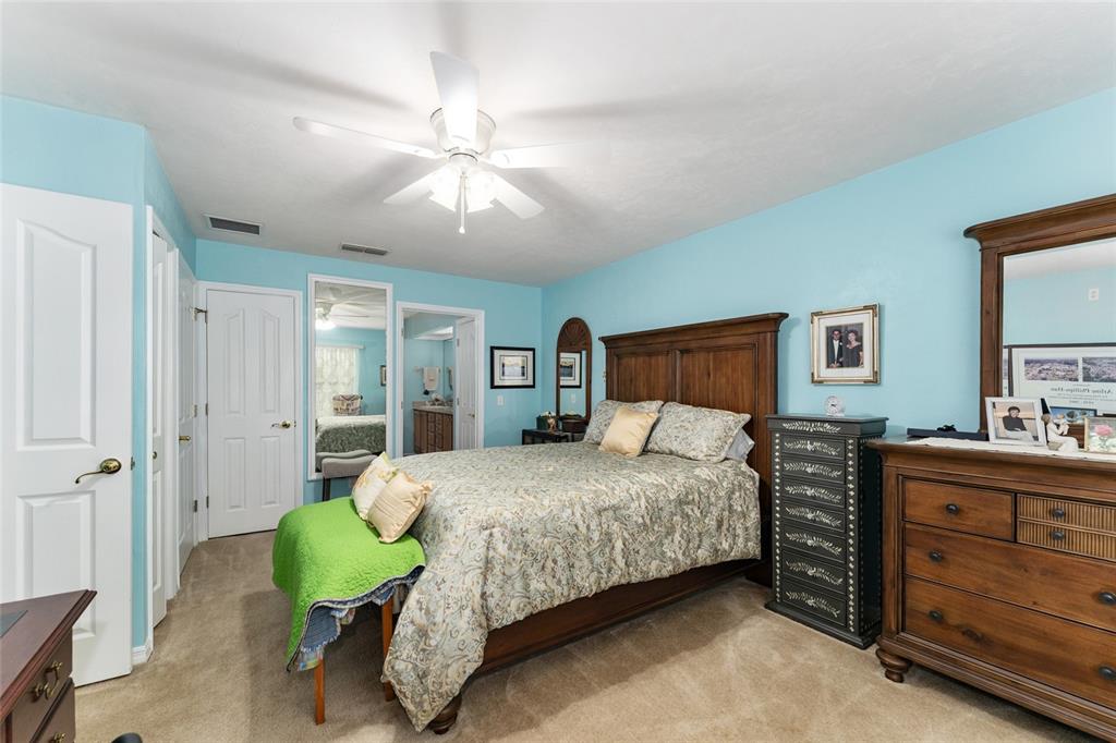 10922 Palmetto Boulevard Alachua, FL 32615 - Photo 18 of 51 a bedroom with a bed and a dresser