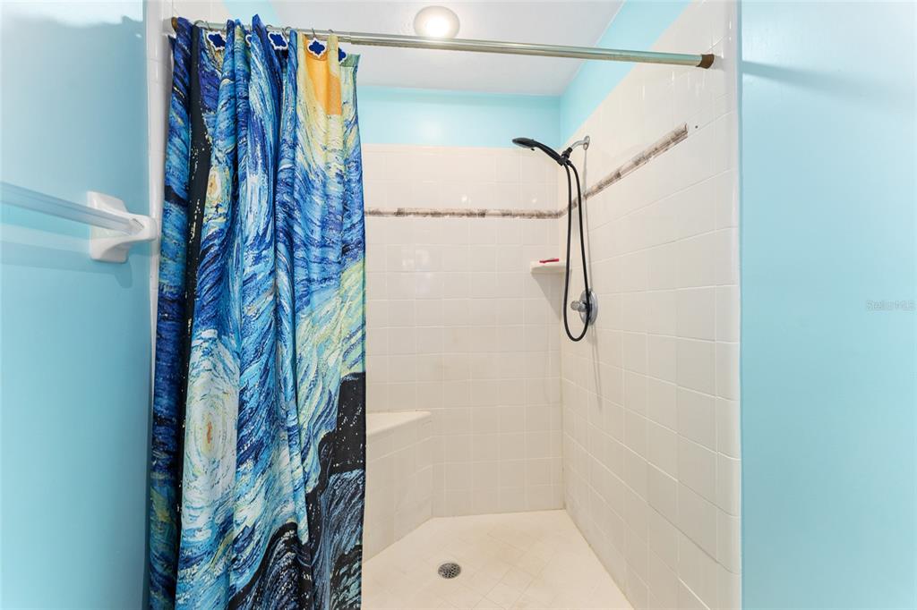 10922 Palmetto Boulevard Alachua, FL 32615 - Photo 22 of 51 a bathroom with a shower curtain and a shower