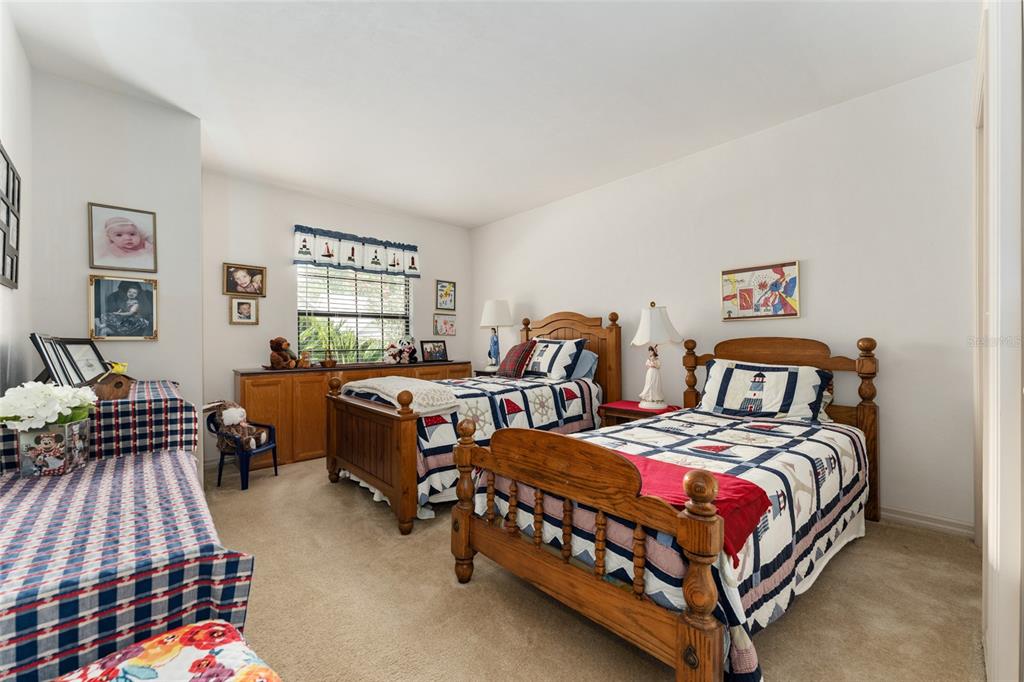 10922 Palmetto Boulevard Alachua, FL 32615 - Photo 24 of 51 a bedroom with two beds and painting on the wall