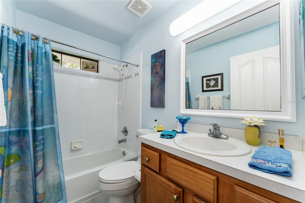 10922 Palmetto Boulevard Alachua, FL 32615 - Photo 27 of 51 a bathroom with a granite countertop sink toilet and shower