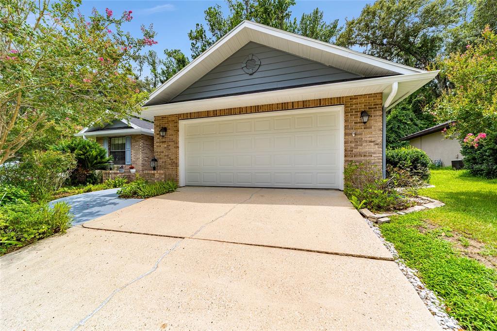 10922 Palmetto Boulevard Alachua, FL 32615 - Photo 3 of 51 a front view of house with garage and yard